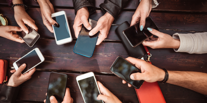 A bunch of business people on their cellphones.