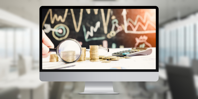 A computer monitor with money and graphs on the screen.