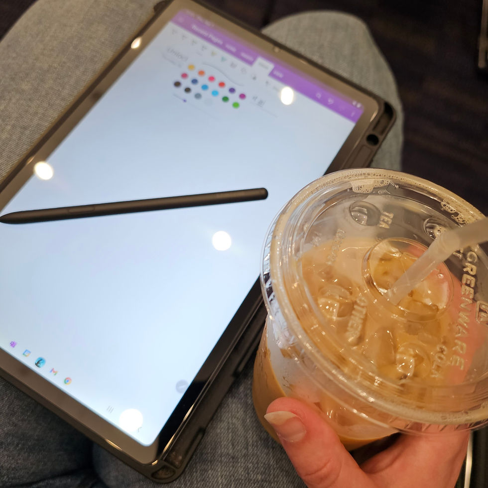A tablet and stylus for note taking and an ices coffee next to it.