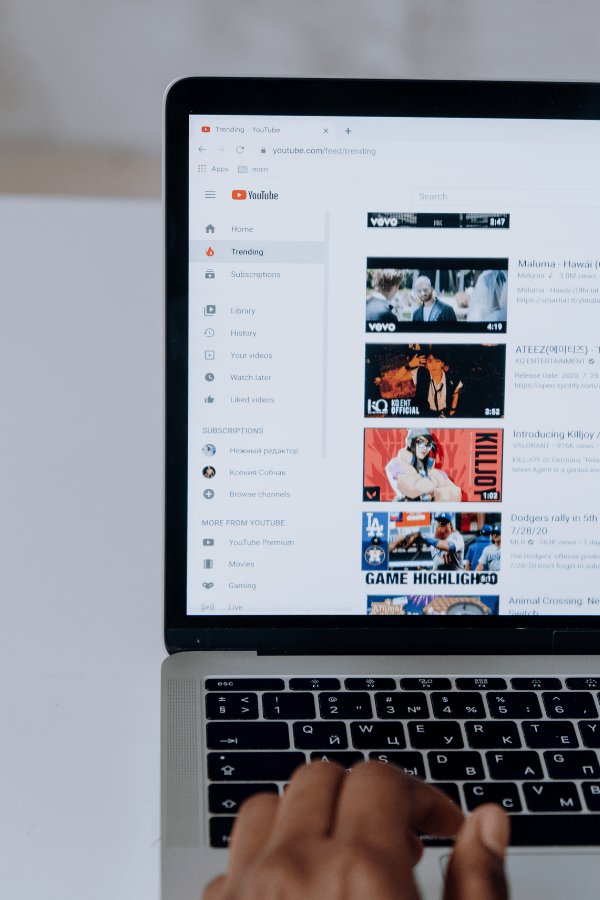 A person on a laptop searching for videos on YouTube.