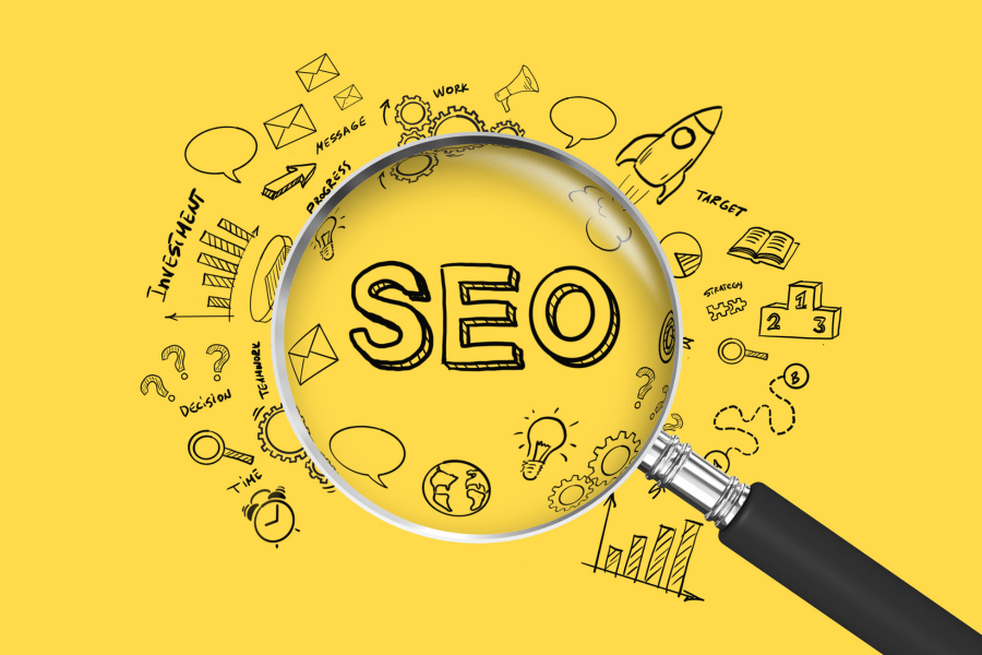 A magnifying glass over the letters SEO with marketing related graphics around it.