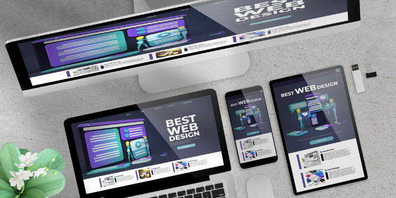A computer monitor, laptop, tablet, and mobile phone displaying the same image that says best website design.