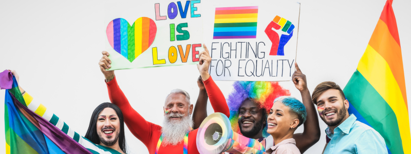 Activists holding pride flags and signs that say, "fighting for equality," and, "love is love"