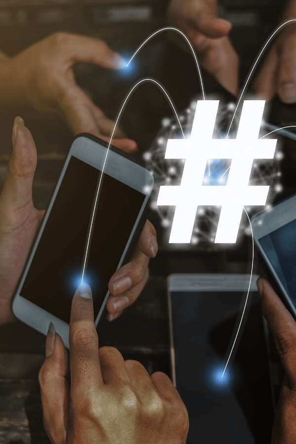 People clicking the screens of their phone with a graphic of a hashtag on top, connecting all the phones.